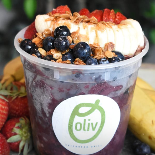 Oliv Epicurean Grill acai bowl with blueberries, strawberries, bananas, and granola.