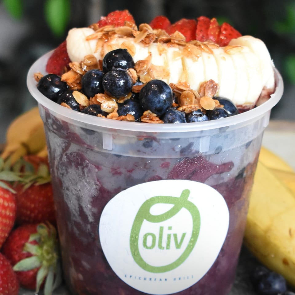 Oliv Epicurean Grill acai bowl with blueberries, strawberries, bananas, and granola.